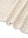 A close-up showing the hemline and detailed knit craftsmanship of the cream crochet cover-up.