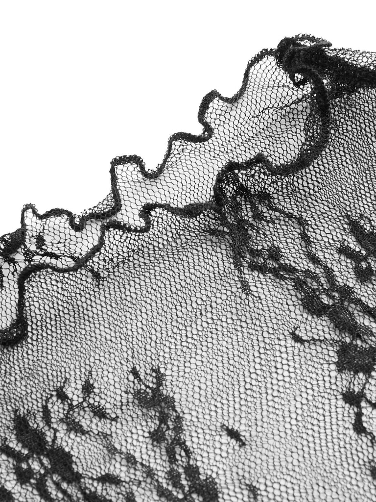 Close-up of the delicate sheer floral lace fabric and scalloped edge detail on the long-sleeve top.