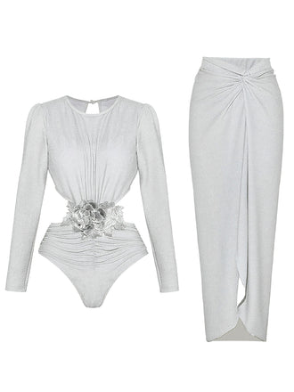 Flat lay view of the silver shimmer bodysuit and the matching high-waisted long skirt laid out separately.