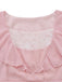 Close-up of the square neckline with delicate floral lace patchwork and soft ruffle trim on the pink dress.