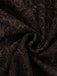 Macro view of the intricate floral lace pattern over the dark brown base fabric.