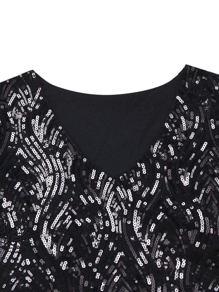 Close-up of the sophisticated V-neckline and intricate sequin embroidery pattern on the black fabric.