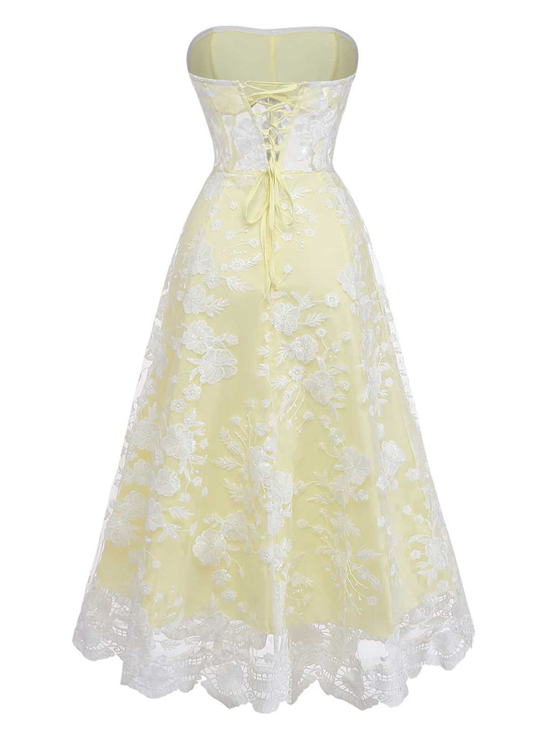 Rear view of the yellow dress highlighting the corset-style lace-up closure at the back.