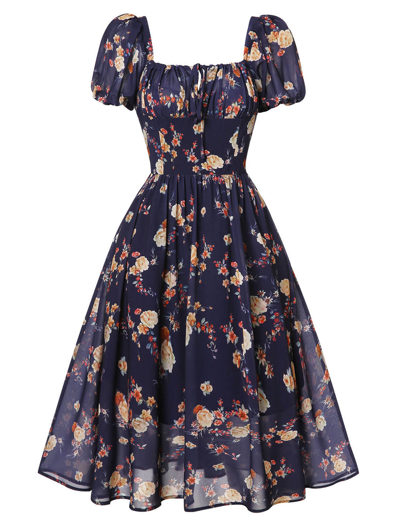 Robe bleu marine à fleurs et manches bouffantes